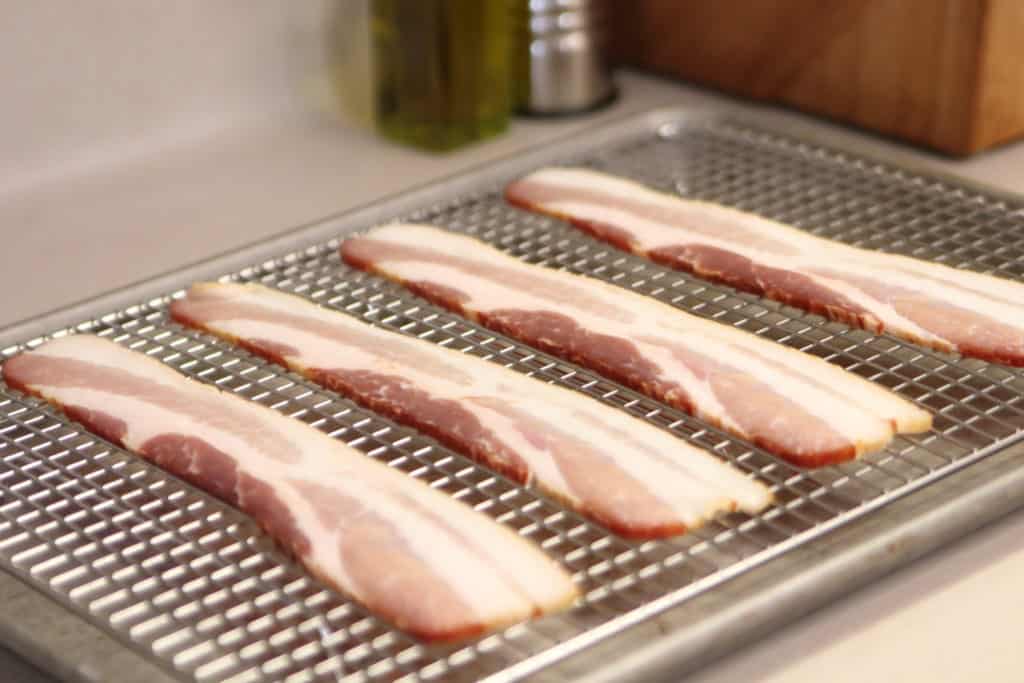 Uncooked Bacon on a cooling rack