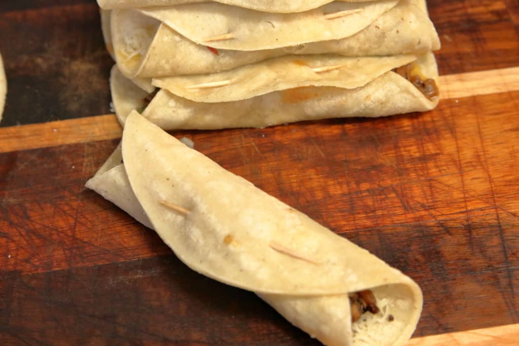 Rolled leftover smoked brisket taquito, prior to frying.