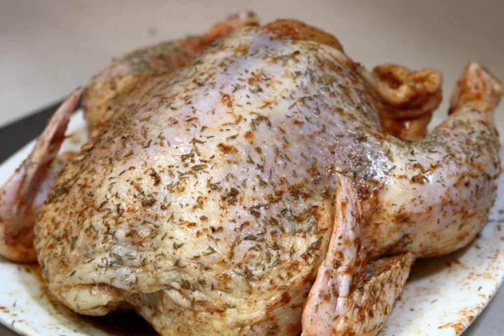Easy Oven Roasted Chicken before it has been cooked. Coated with seasoning.