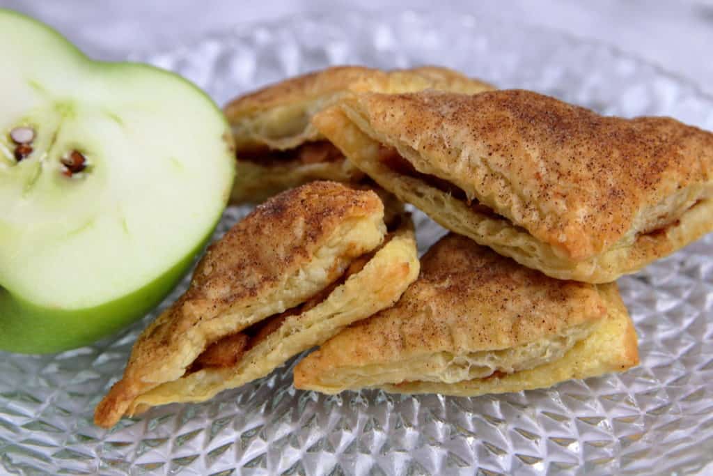 Puff pastry apple pie bites coated in cinnamon sugar.