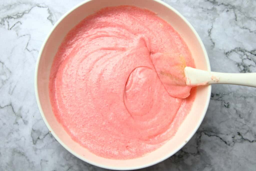 Batter for strawberry cupakes in a white bowl
