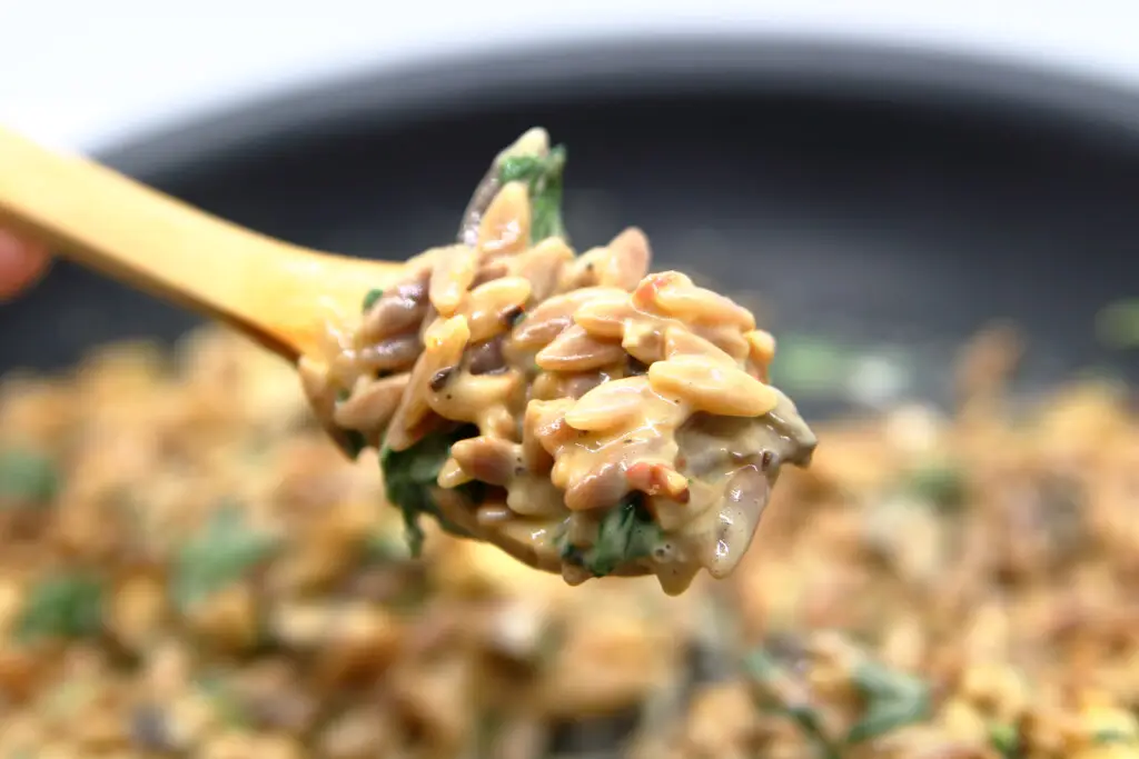 Spinach and parmesan orzo on a spoon