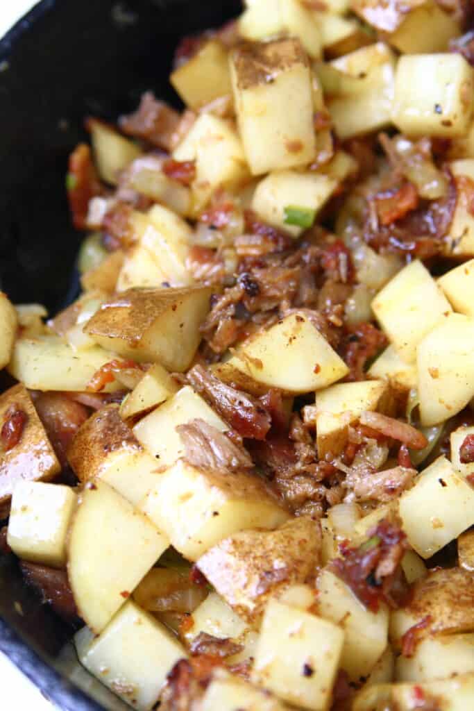 Skillet of potatoes, rib meat, and onions.