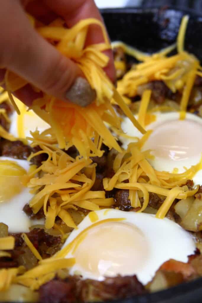 Adding cheese to the top of the dish