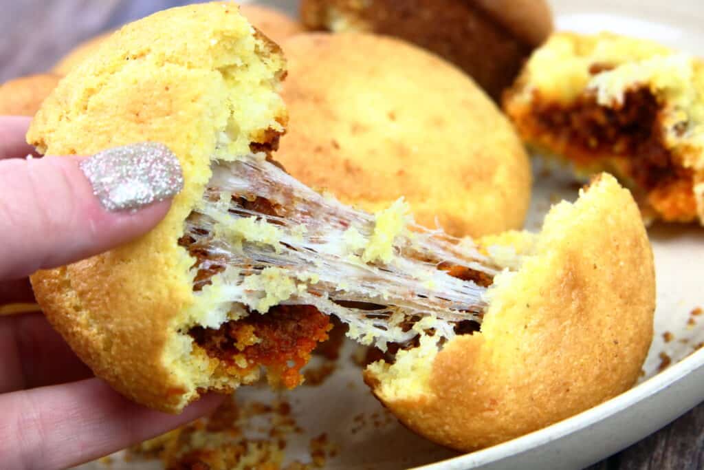 chorizo corn muffins being pulled apart and showing stringy cheese