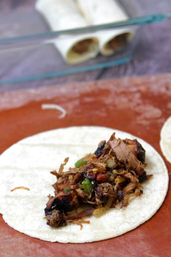 Pulled pork stuffing about to be rolled in a corn tortilla