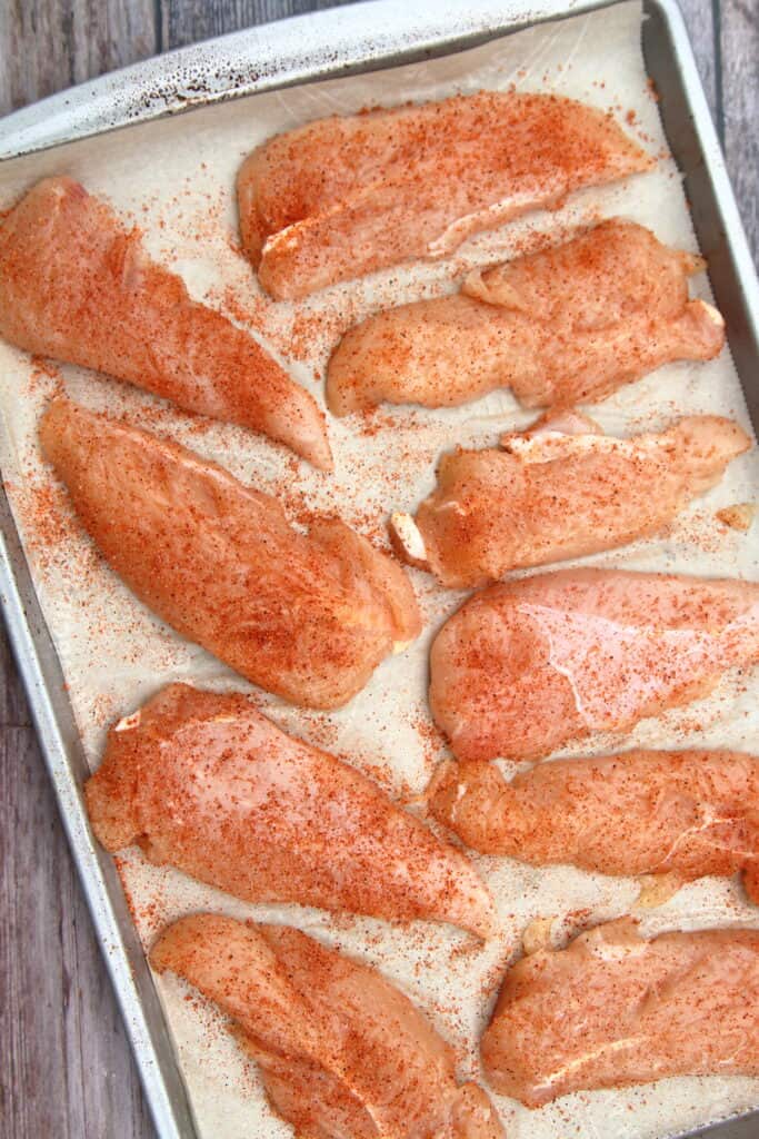 tray of seasoned, uncooked chicken tenders
