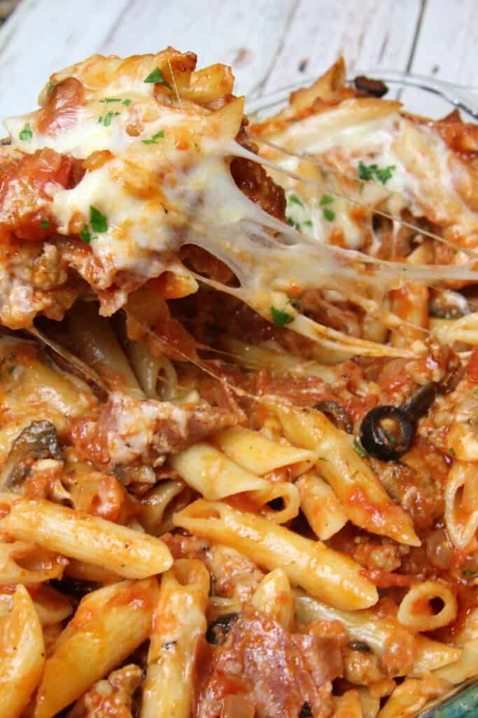 stringy cheese in a pan of meaty pasta bake