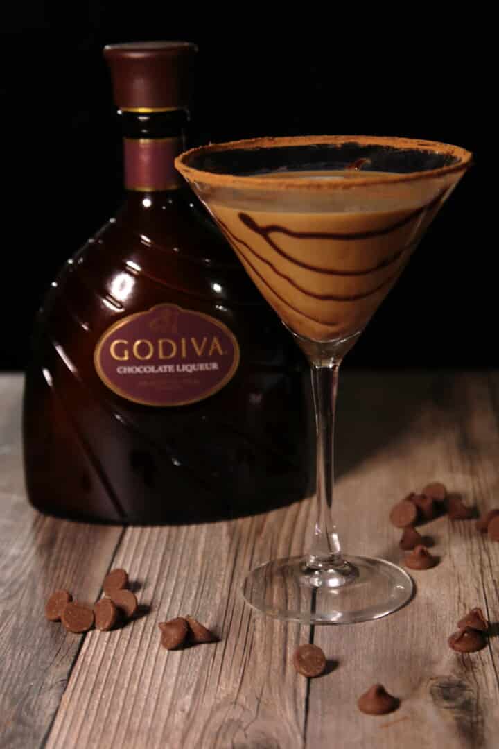 chocolate martini in a glass next to godiva liqueur