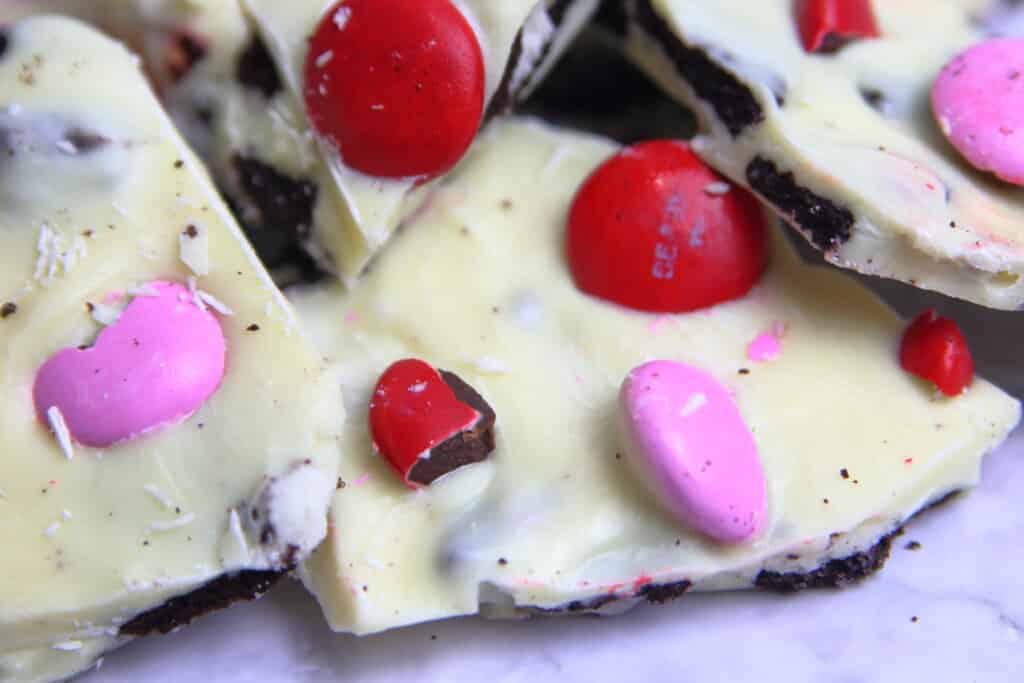 White chocolate oreo bark closeup with pink and red M&Ms