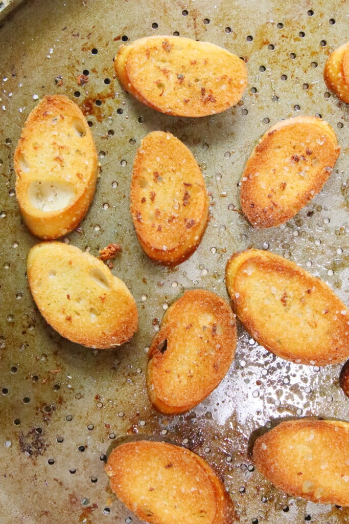 slices of golden brown crostini coming out of the oven