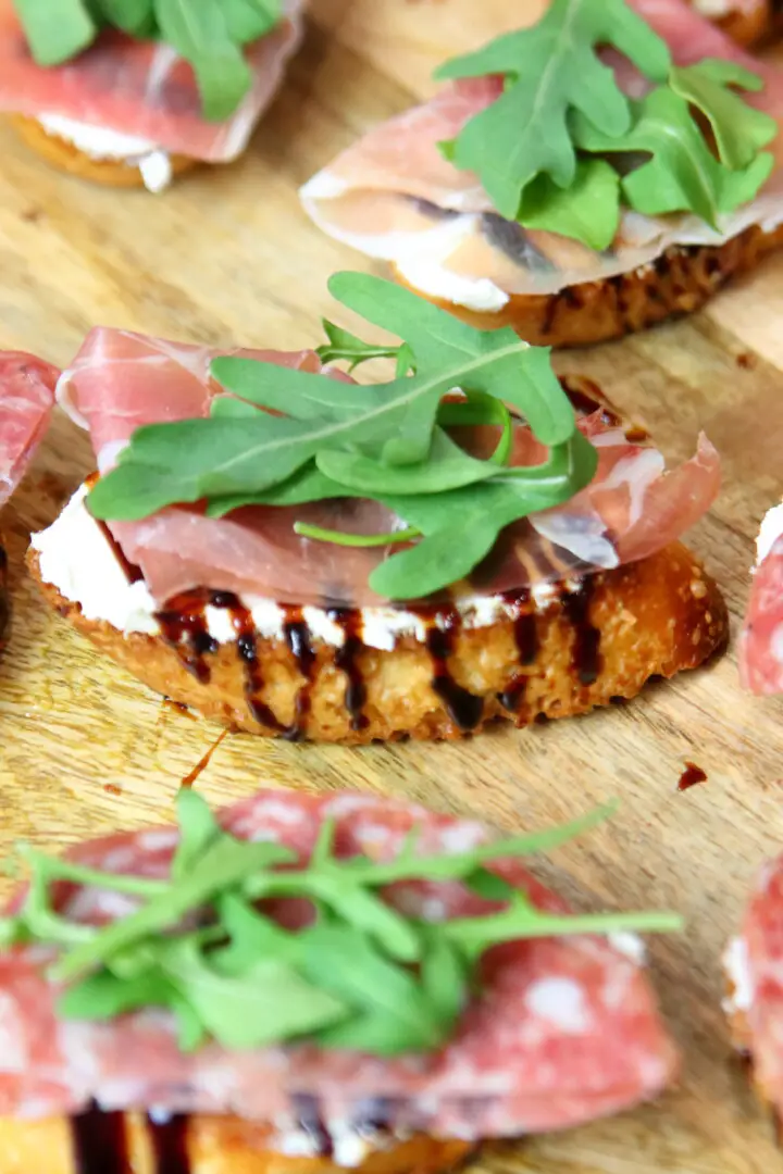 Goat cheese crostini on a wooden platter