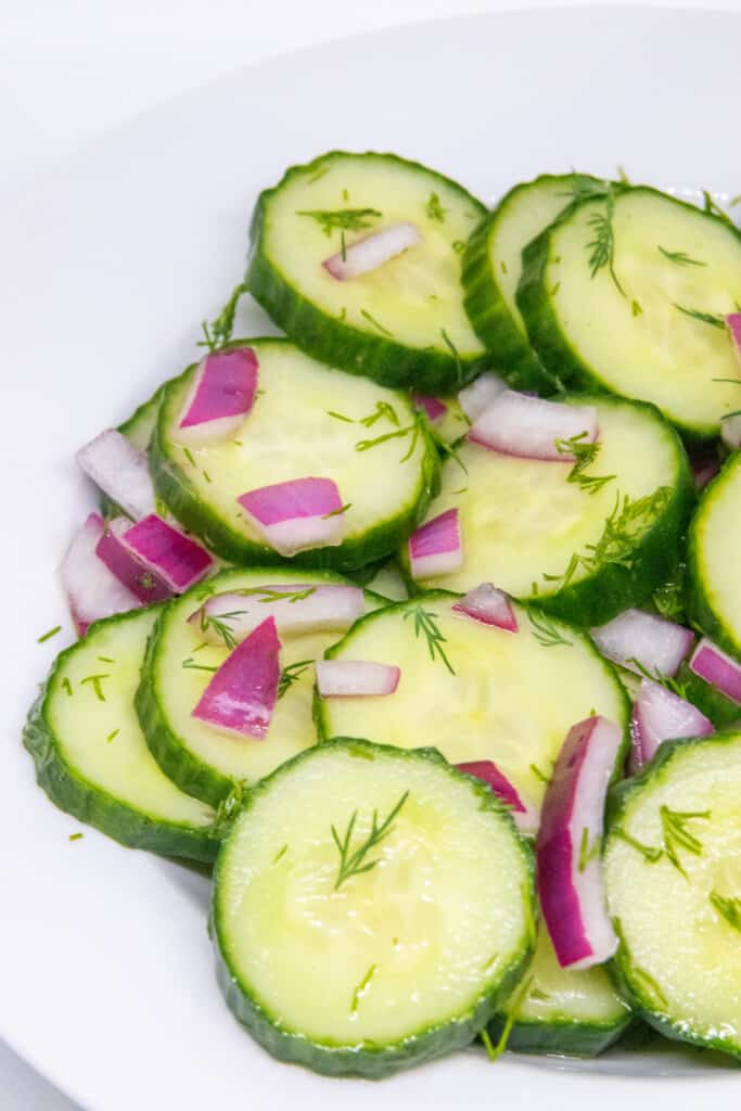 side shot of sliced cucumber dill salad in a bowl
