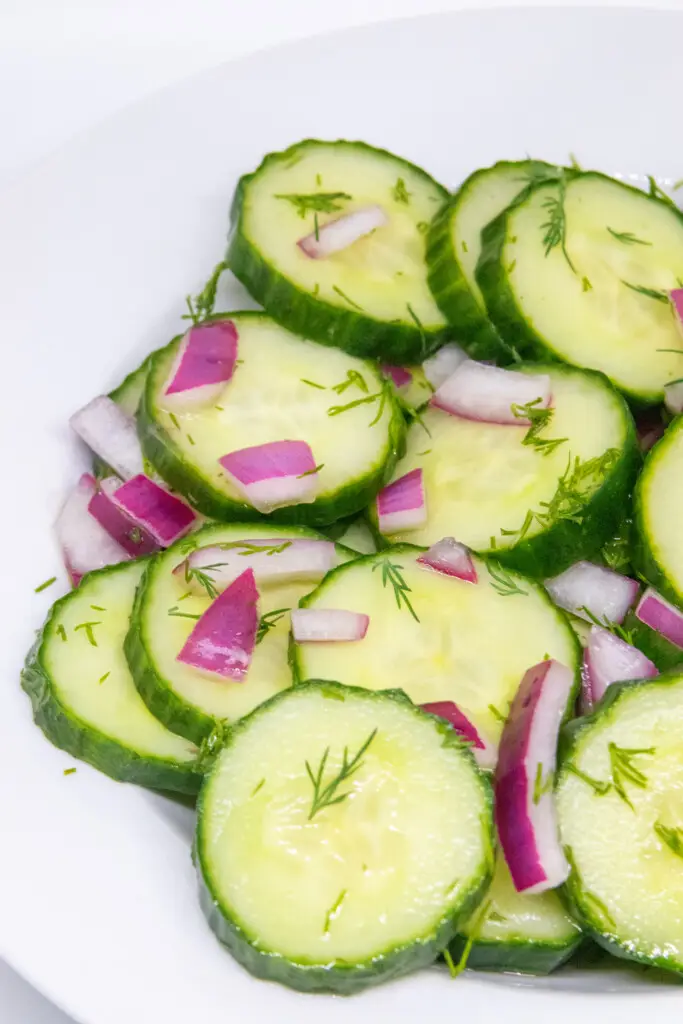 side shot of sliced cucumber dill salad in a bowl