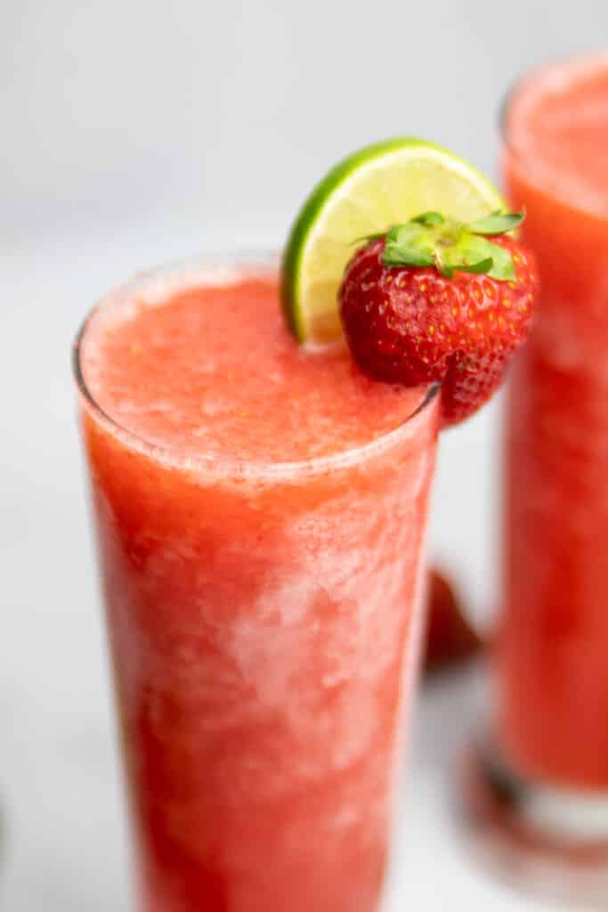 closeup of Frozen Strawberry Limeade Vodka slush with a second one in the background
