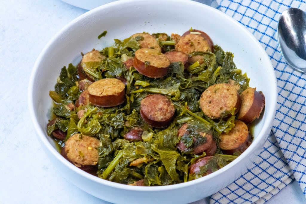 bowl of mustard greens and sausage.