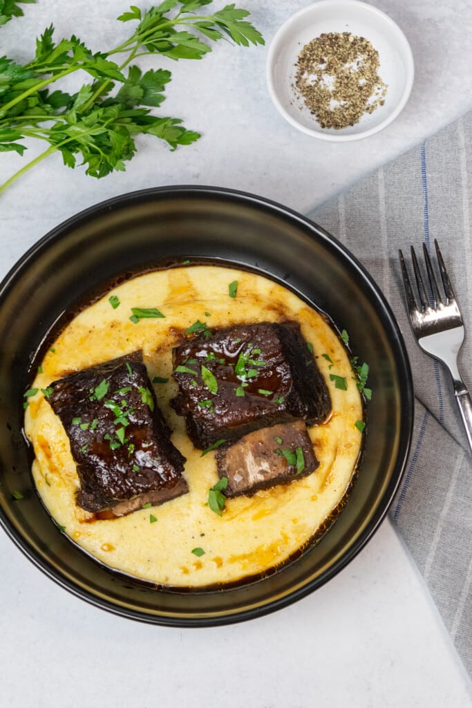 overhead shot of wine braised short ribs over a bed of polenta