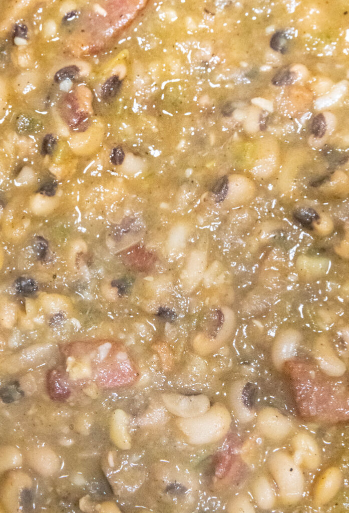 close up of mushy black eyed peas in the pot
